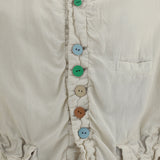 Jacket with multicolored button