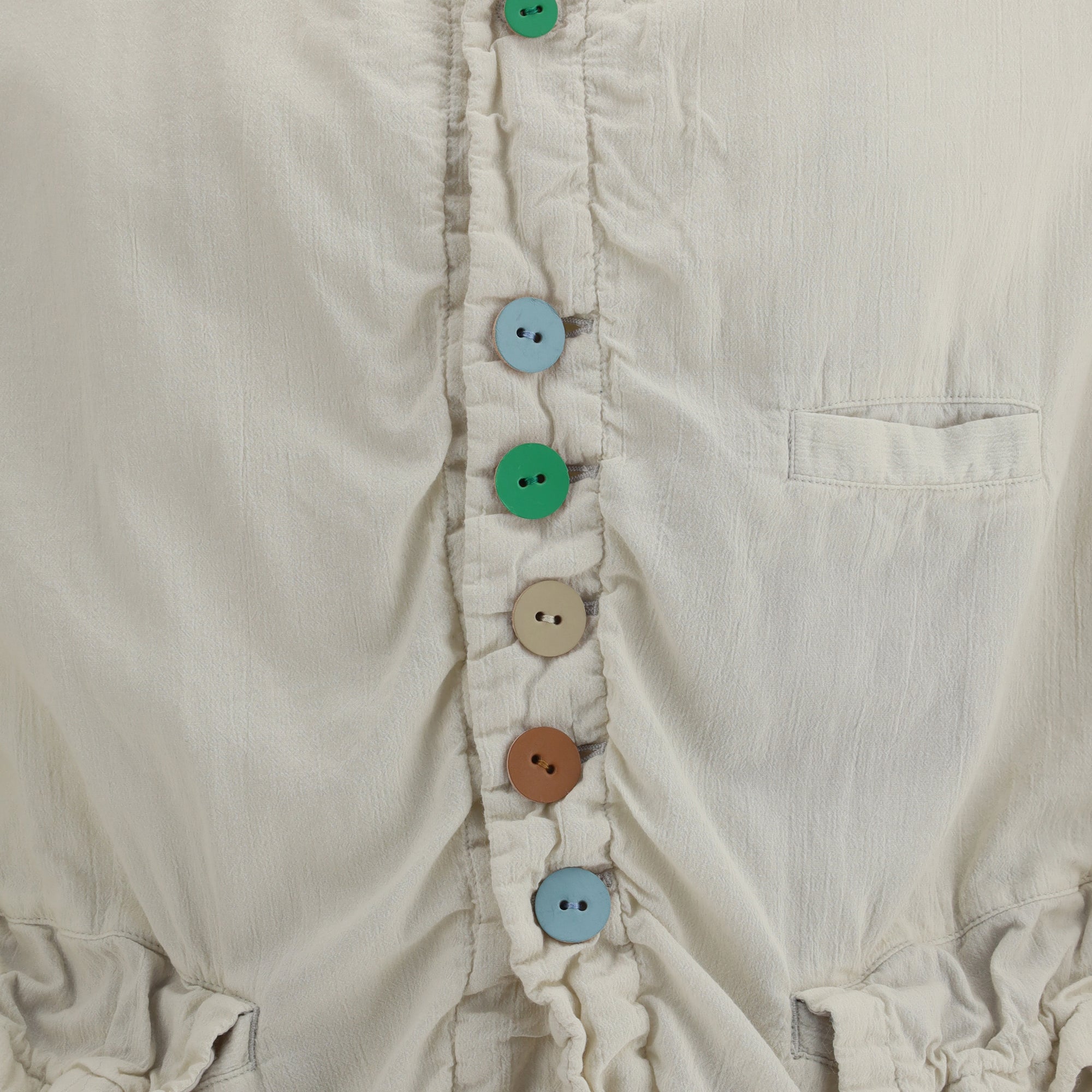 Jacket with multicolored button